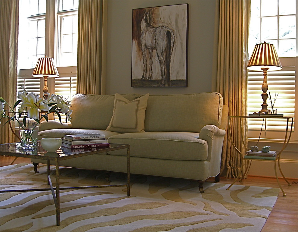 Traditional family room in Atlanta with beige walls and medium hardwood floors.
