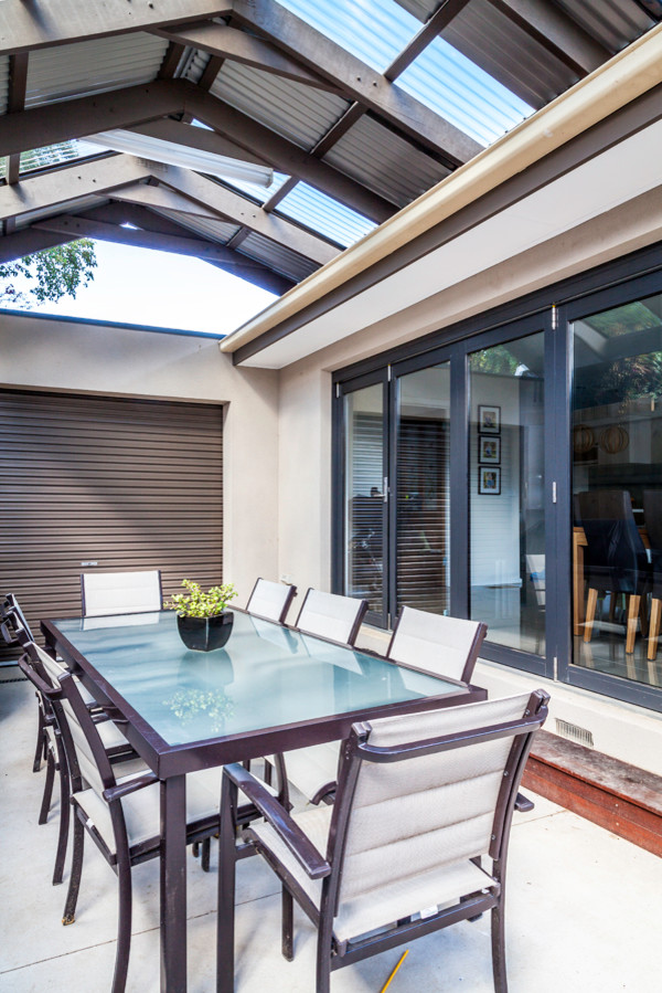 Photo of a contemporary backyard deck in Melbourne with a pergola.