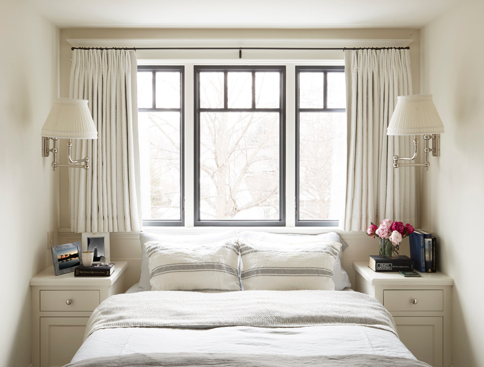 This is an example of a traditional bedroom in Milwaukee with white walls.
