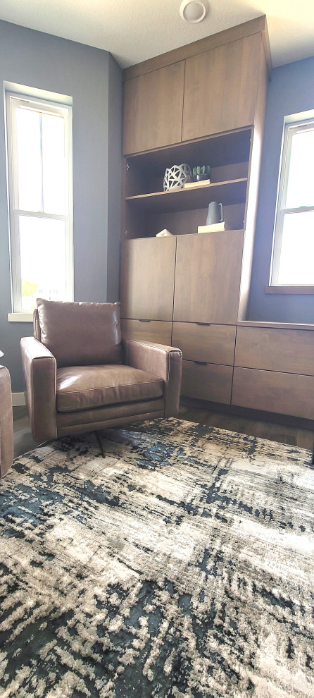 Example of a transitional freestanding desk medium tone wood floor and brown floor home office design in Cedar Rapids with gray walls