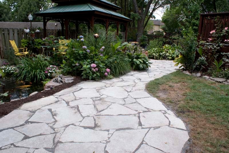 Inspiration for a mid-sized asian backyard partial sun formal garden for spring in Chicago with a garden path and natural stone pavers.