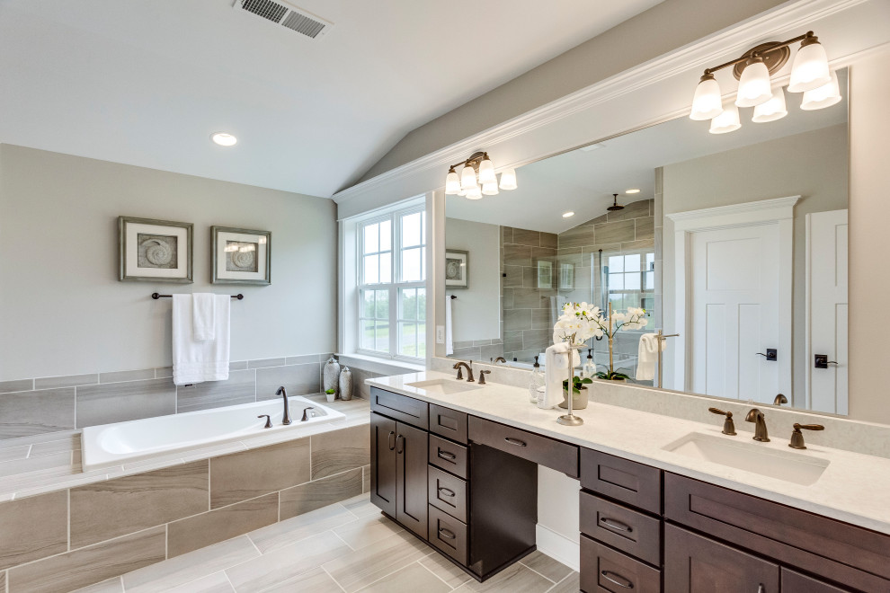 Inspiration for a transitional master bathroom in DC Metro with shaker cabinets, a drop-in tub, an alcove shower, grey walls, an undermount sink, grey floor and a hinged shower door.
