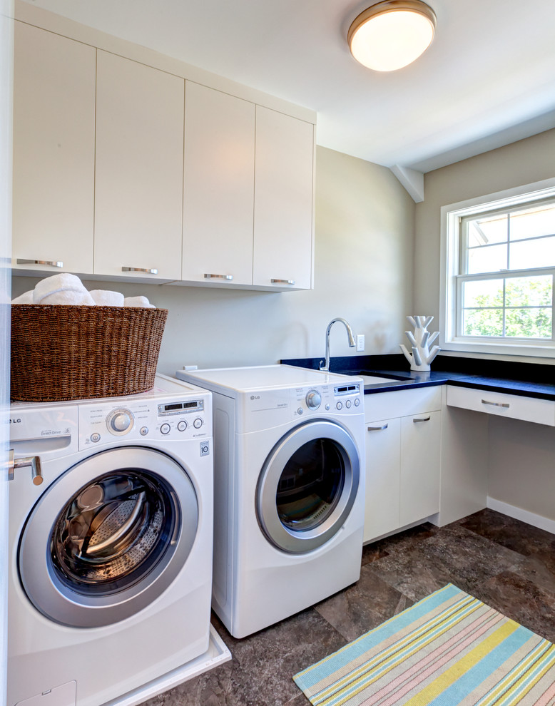 Mid-sized contemporary single-wall dedicated laundry room in Minneapolis with an undermount sink, flat-panel cabinets, white cabinets, grey walls and a side-by-side washer and dryer.