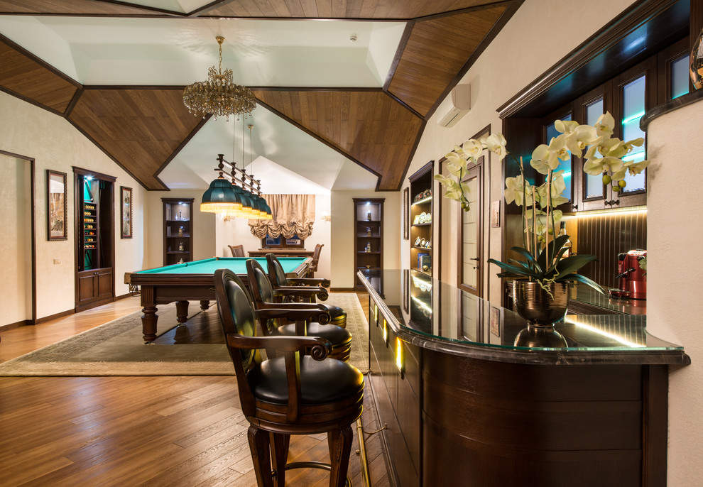 Expansive country u-shaped seated home bar in Moscow with dark wood cabinets, marble benchtops, brown splashback, timber splashback, medium hardwood floors, recessed-panel cabinets and brown floor.