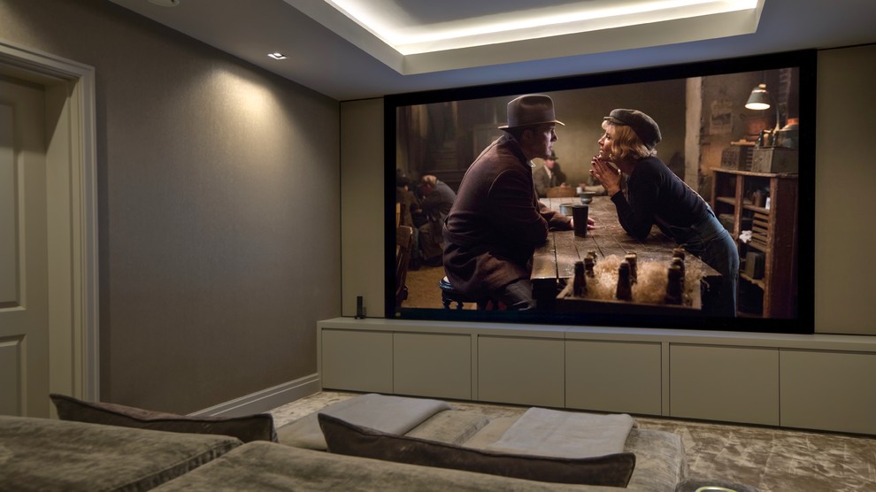 Inspiration for a large contemporary enclosed home theatre in Kent with brown walls, carpet, a projector screen and beige floor.