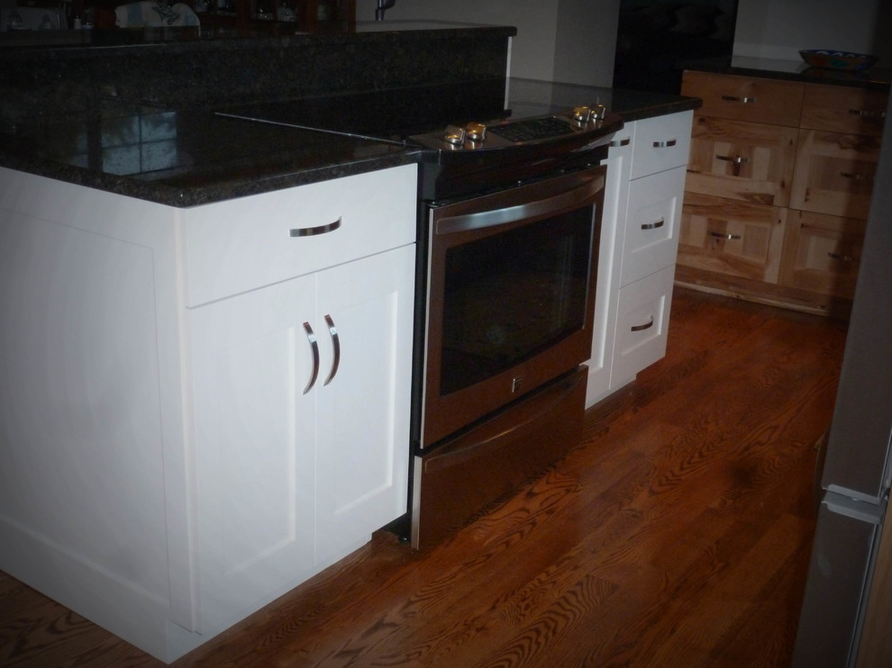 Inspiration for a large rustic u-shaped medium tone wood floor and brown floor eat-in kitchen remodel in Seattle with a double-bowl sink, shaker cabinets, light wood cabinets, granite countertops, stainless steel appliances and an island