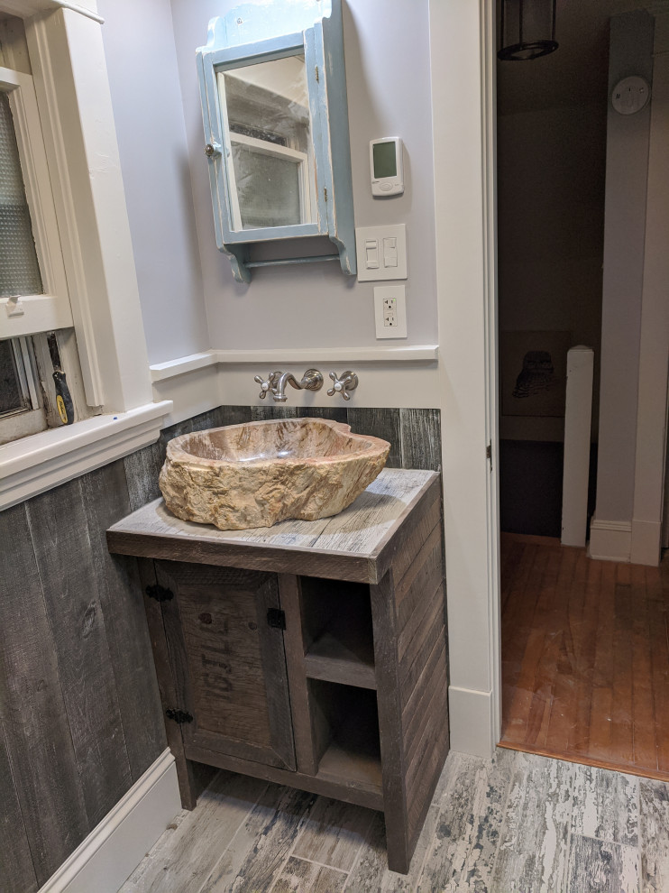 Inspiration for a rustic bathroom in Cedar Rapids with a vessel sink and a single sink.