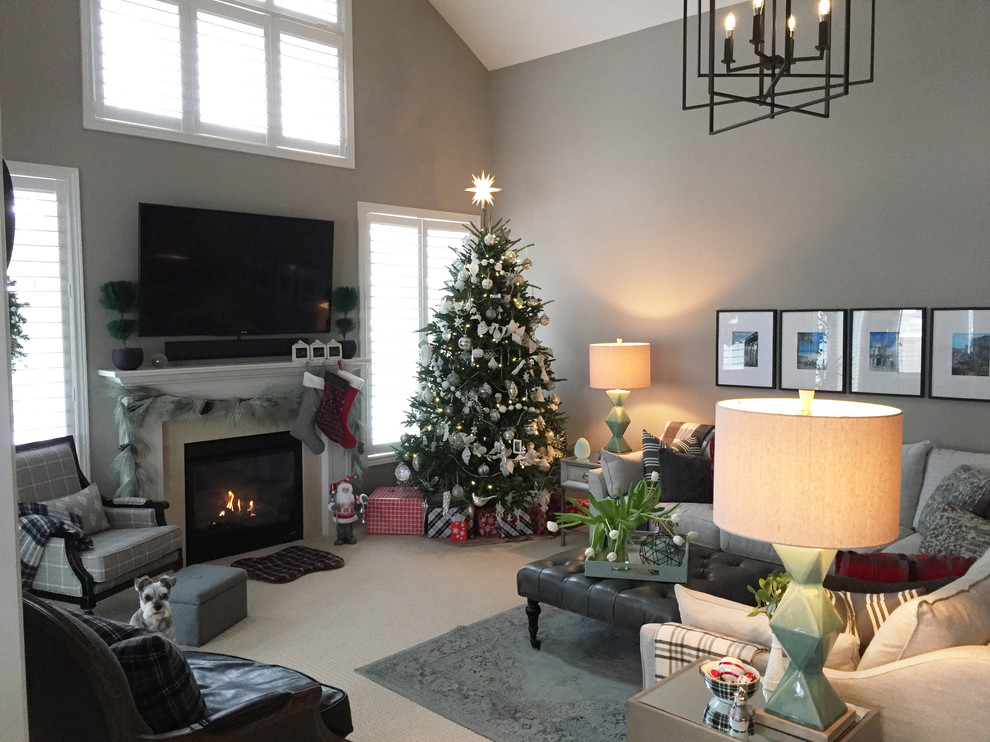 Design ideas for a transitional family room in Toronto with grey walls, carpet, a standard fireplace, a stone fireplace surround, a wall-mounted tv and beige floor.