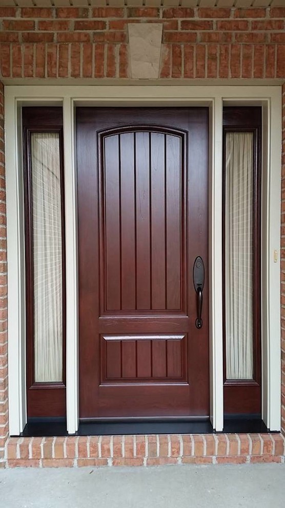 Design ideas for a large traditional front door in New York with red walls, concrete floors, a single front door and a dark wood front door.