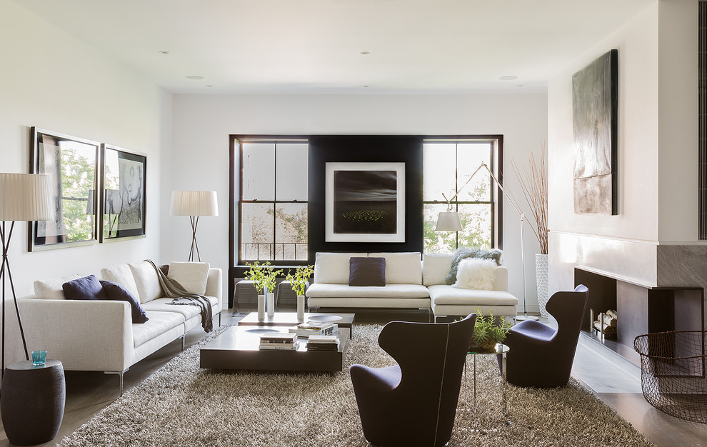 This is an example of a large contemporary formal enclosed living room in Boston with white walls, no tv, dark hardwood floors, a standard fireplace and a concrete fireplace surround.