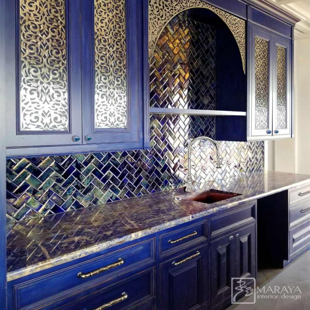 Inspiration for a mid-sized mediterranean galley porcelain tile, gray floor and coffered ceiling enclosed kitchen remodel in Santa Barbara with an undermount sink, raised-panel cabinets, blue cabinets, granite countertops, blue backsplash, ceramic backsplash, paneled appliances, an island and blue countertops