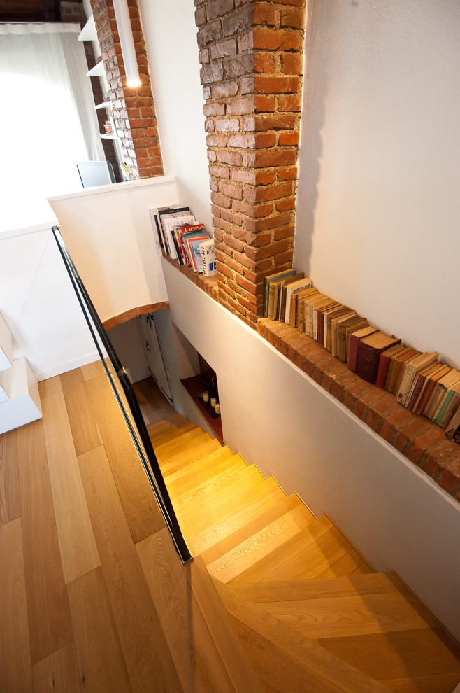 This is an example of a mid-sized contemporary wood straight staircase in Milan with wood risers.