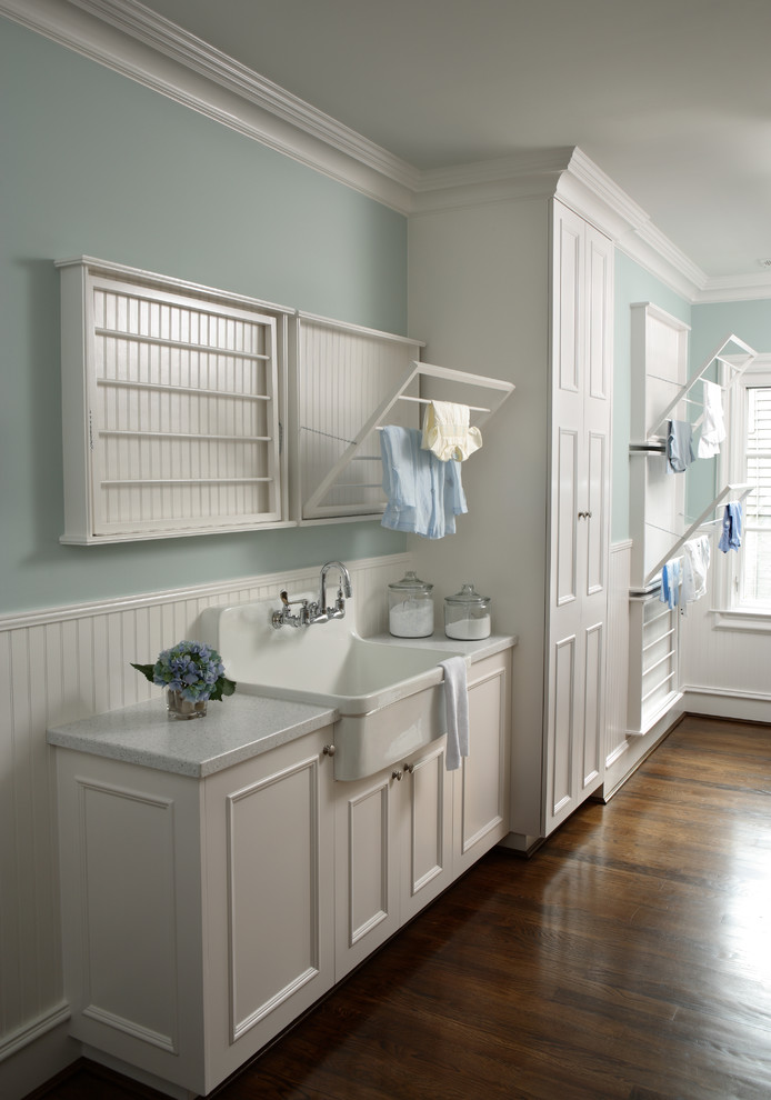 This is an example of a traditional laundry room in Atlanta with white cabinets, white benchtop and a drop-in sink.