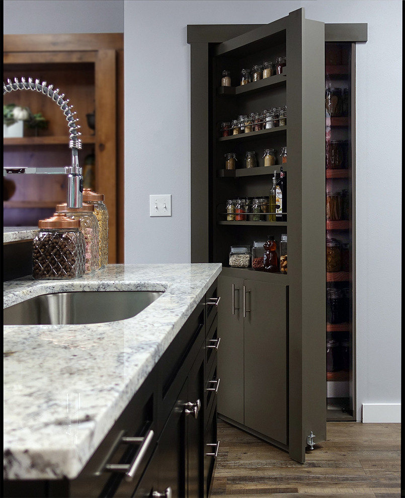 Inspiration for a large kitchen pantry in Los Angeles with a single-bowl sink, flat-panel cabinets, grey cabinets, granite benchtops, black splashback, stainless steel appliances, linoleum floors, brown floor and grey benchtop.