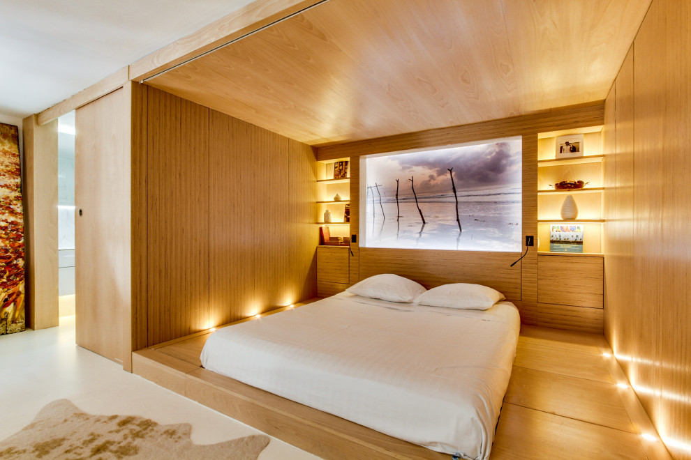 Photo of a contemporary bedroom in Paris with brown walls, medium hardwood floors, brown floor and wood walls.