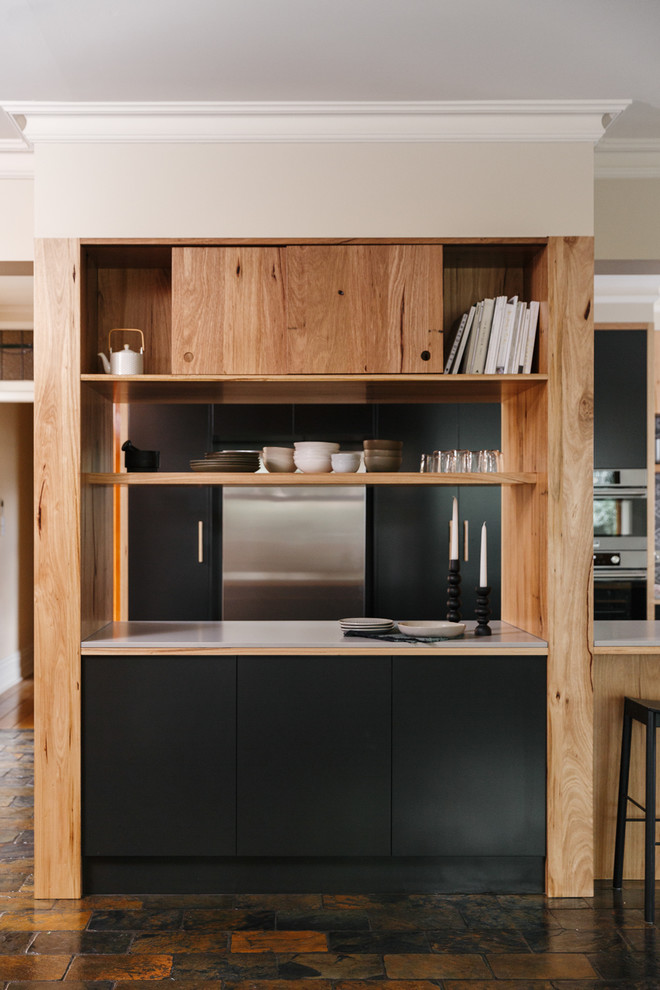 Photo of a large modern u-shaped open plan kitchen in Adelaide with flat-panel cabinets, medium wood cabinets, solid surface benchtops, grey splashback, ceramic splashback, stainless steel appliances, slate floors, with island and multi-coloured floor.