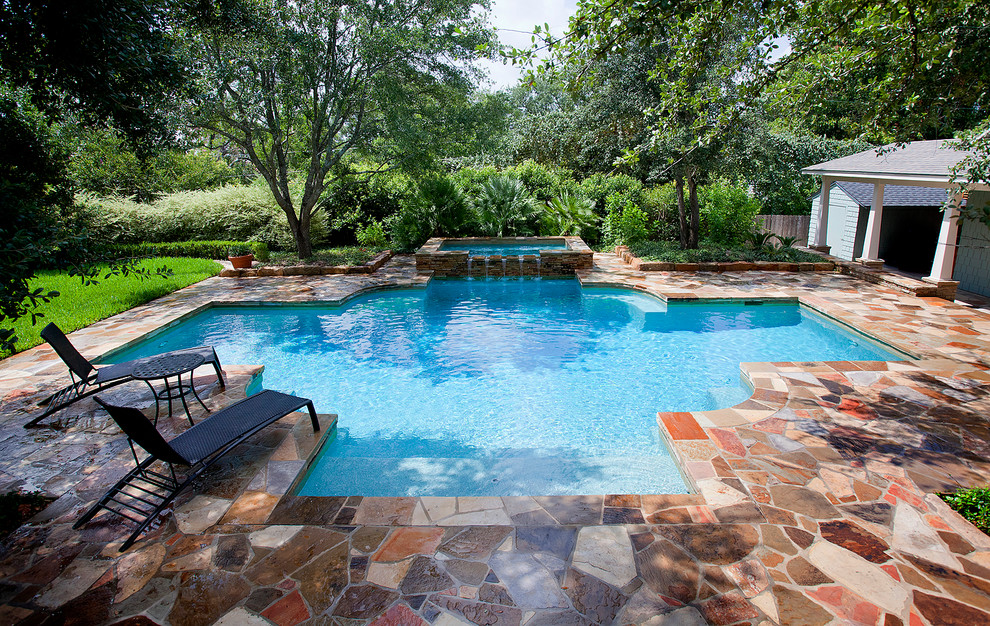 Photo of an expansive traditional backyard custom-shaped lap pool in Austin with natural stone pavers and a pool house.
