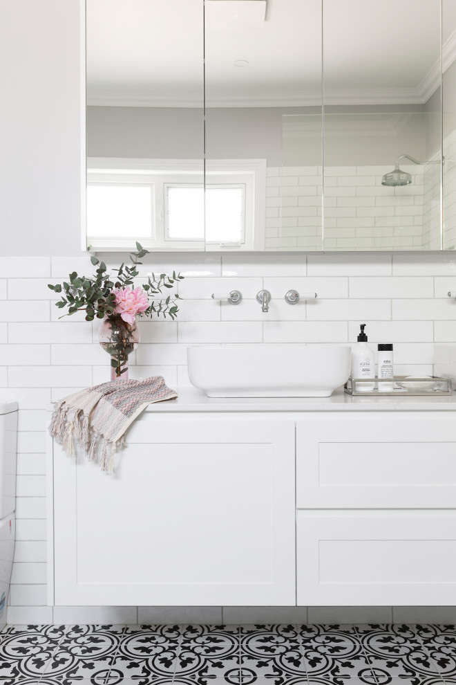 Photo of a traditional bathroom in Canberra - Queanbeyan with shaker cabinets, white cabinets, a freestanding bath, a walk-in shower, a one-piece toilet, white tiles, metro tiles, grey walls, porcelain flooring, a vessel sink, engineered stone worktops, an open shower, white worktops, double sinks and a floating vanity unit.