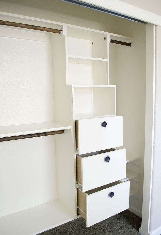 Photo of a small transitional gender-neutral built-in wardrobe in Boston with open cabinets and white cabinets.