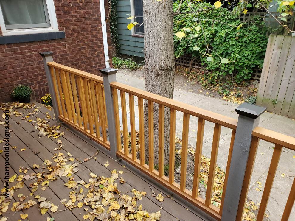 Inspiration for a country backyard and ground level deck in Cleveland with with skirting and wood railing.