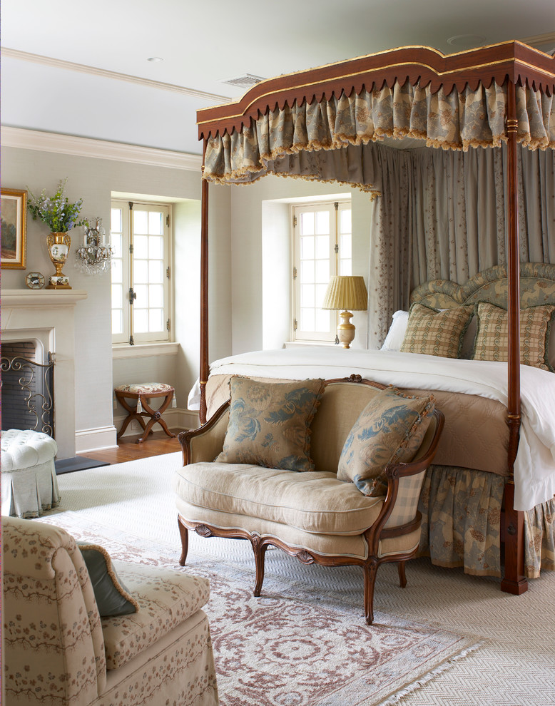 Inspiration for a large french country master bedroom remodel in New York with beige walls and a standard fireplace