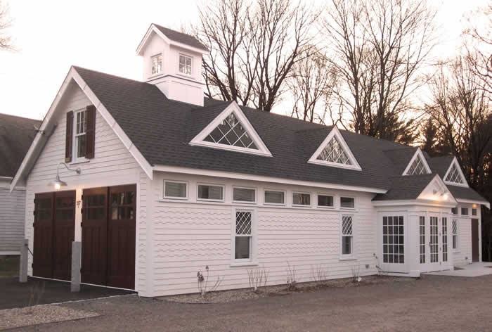 Mid-sized country two-storey white house exterior in Boston with wood siding, a gable roof and a shingle roof.