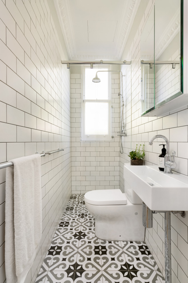 This is an example of a transitional bathroom in Sydney with white tile, subway tile, a console sink, multi-coloured floor and a single vanity.
