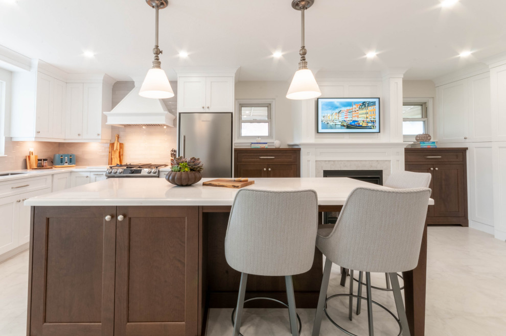 Inspiration for a large transitional l-shaped porcelain tile and white floor eat-in kitchen remodel in Toronto with an undermount sink, recessed-panel cabinets, white cabinets, quartz countertops, gray backsplash, ceramic backsplash, stainless steel appliances, an island and white countertops