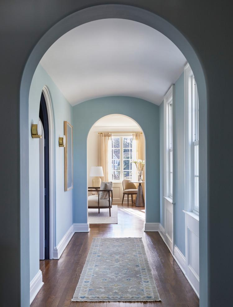 Photo of a mid-sized transitional foyer in New York with white walls, dark hardwood floors, a single front door, a white front door and brown floor.
