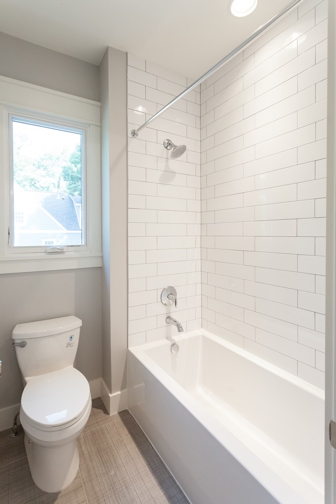 Photo of a contemporary kids bathroom in DC Metro with flat-panel cabinets, purple cabinets, an alcove tub, a shower/bathtub combo, a two-piece toilet, white tile, subway tile, grey walls, porcelain floors, an undermount sink, engineered quartz benchtops, grey floor, a shower curtain and white benchtops.