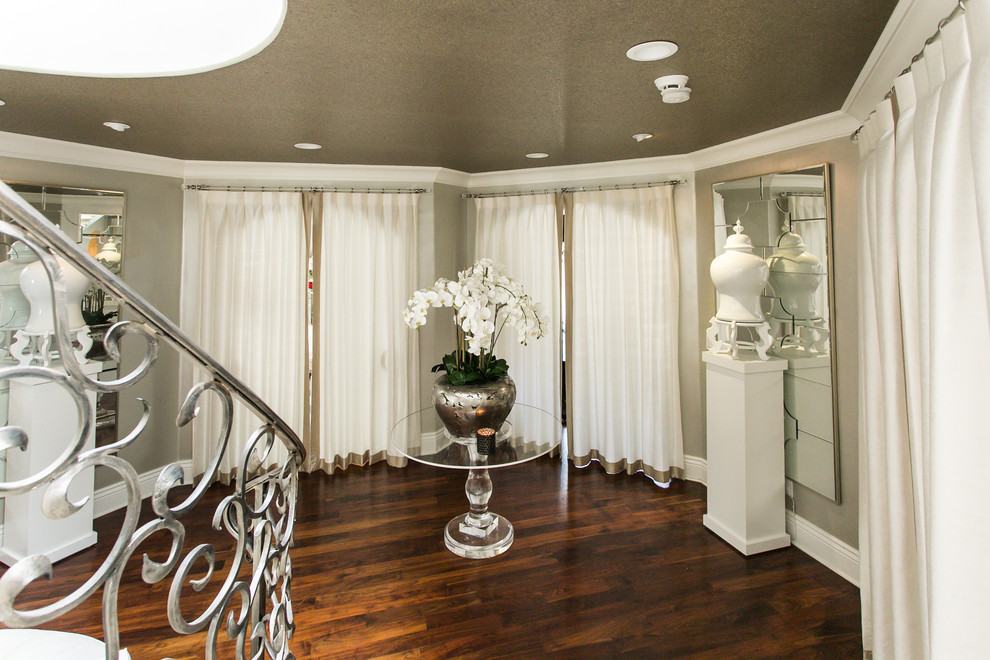 Foyer - mid-sized transitional medium tone wood floor and brown floor foyer idea with white walls