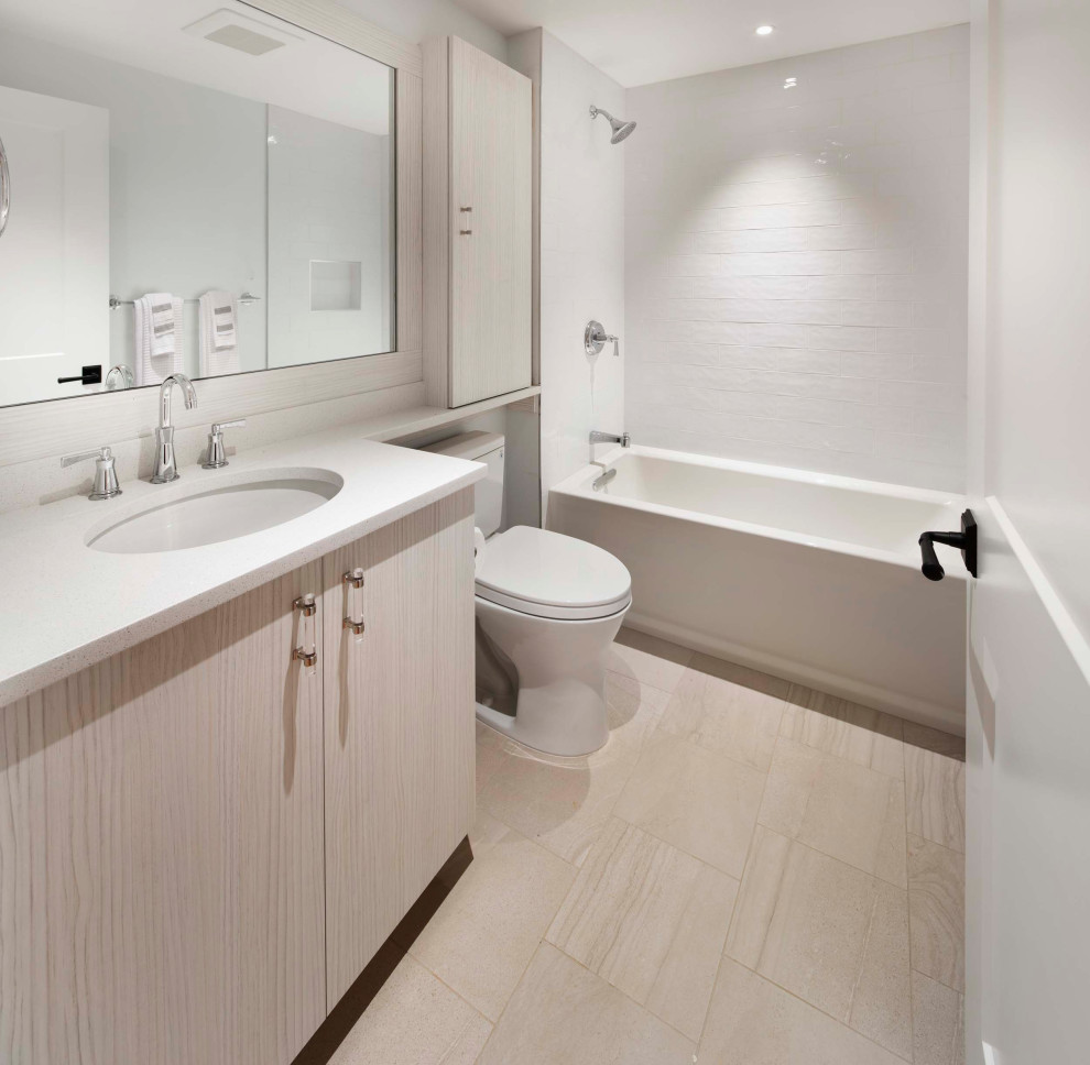 Design ideas for a transitional bathroom in DC Metro with flat-panel cabinets, light wood cabinets, white walls, marble floors, an undermount sink, marble benchtops, beige floor, white benchtops, a floating vanity, a drop-in tub, a shower/bathtub combo, a one-piece toilet, white tile, cement tile, a shower curtain and a single vanity.