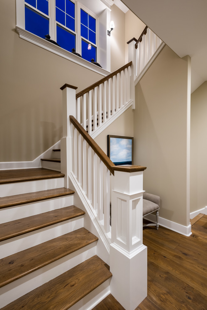 Design ideas for a mid-sized contemporary wood u-shaped staircase in New York with painted wood risers and wood railing.