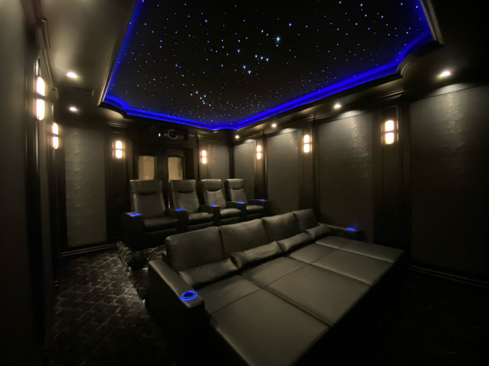 Photo of a mid-sized contemporary home theatre in Los Angeles with black walls.