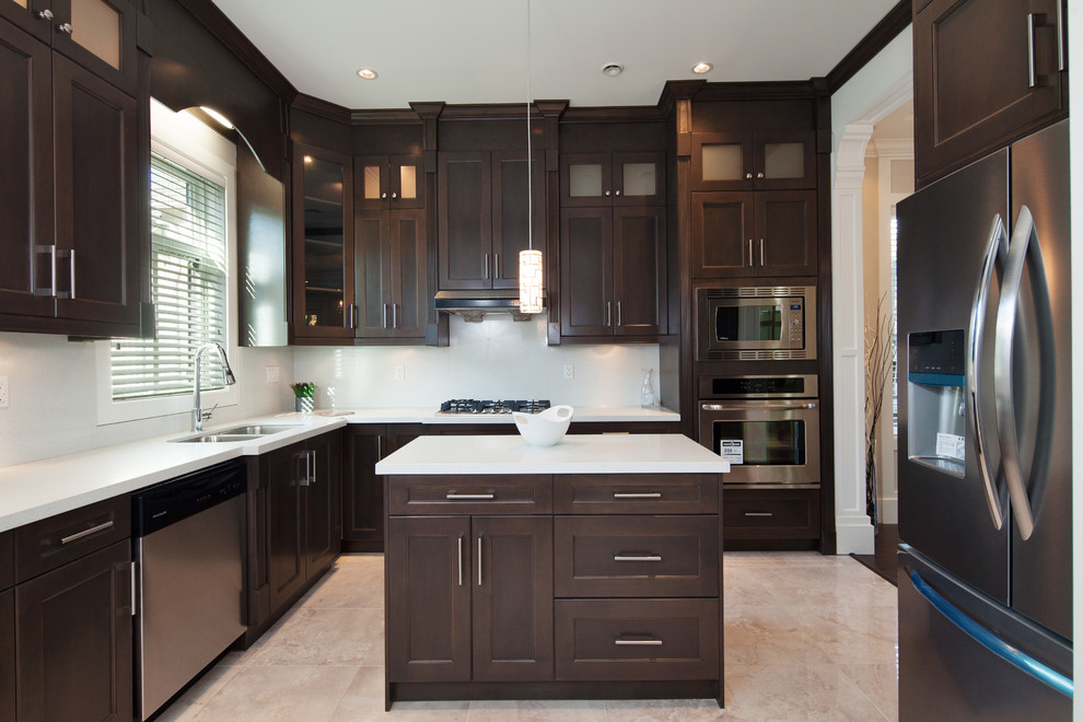 Inspiration for a mid-sized contemporary l-shaped eat-in kitchen in Vancouver with flat-panel cabinets, dark wood cabinets, granite benchtops, white splashback, stone slab splashback, stainless steel appliances, ceramic floors, with island, a double-bowl sink, beige floor and white benchtop.