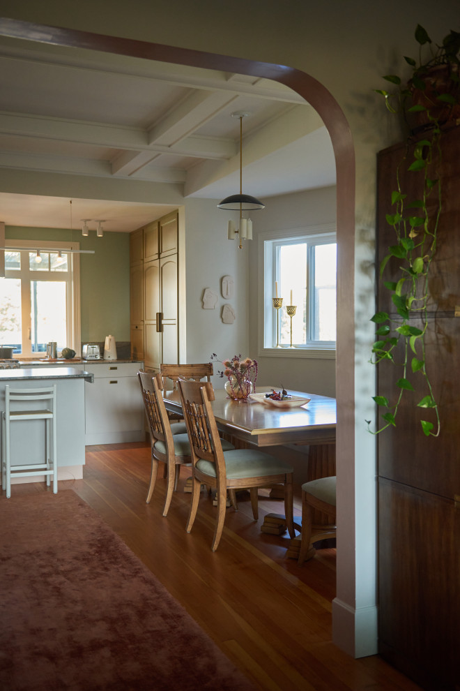 Foto på ett stort funkis kök med matplats, med beige väggar, mellanmörkt trägolv, en standard öppen spis, en spiselkrans i tegelsten och brunt golv