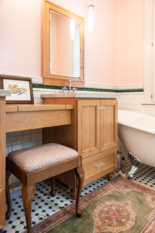 Photo of a small eclectic master bathroom in San Luis Obispo with recessed-panel cabinets, medium wood cabinets, a claw-foot tub, white tile, subway tile, pink walls, porcelain floors, an integrated sink, multi-coloured floor and multi-coloured benchtops.