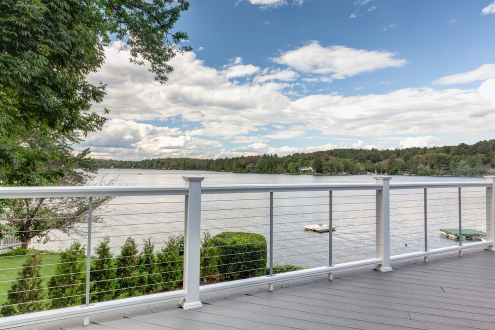 Transitional backyard deck in Boston with with dock.