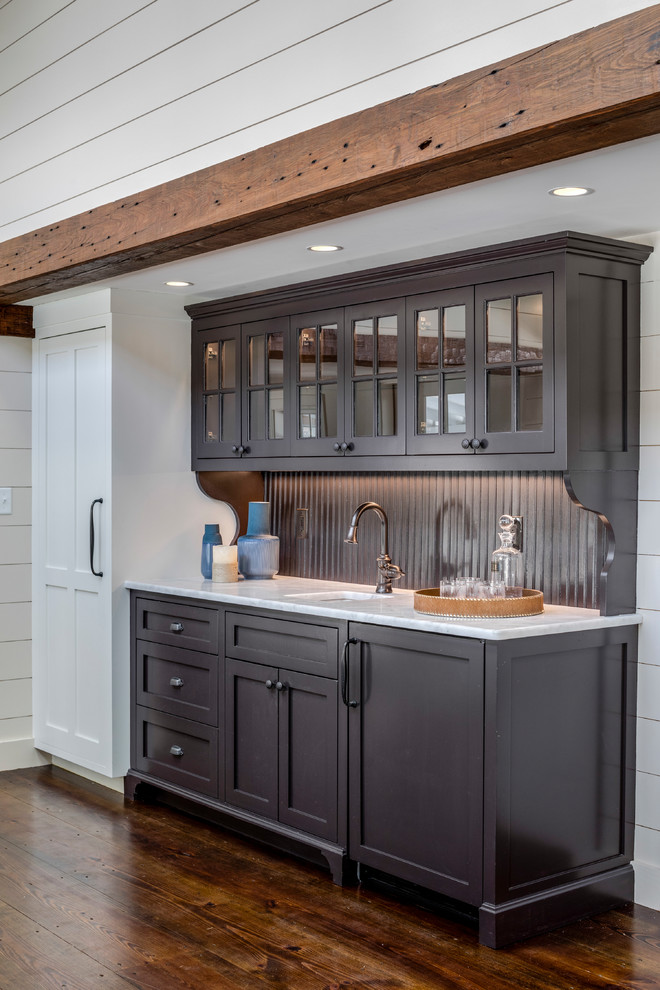 Inspiration for a mid-sized transitional single-wall wet bar in Boston with an undermount sink, flat-panel cabinets, brown cabinets, marble benchtops, timber splashback, dark hardwood floors, brown floor and yellow benchtop.