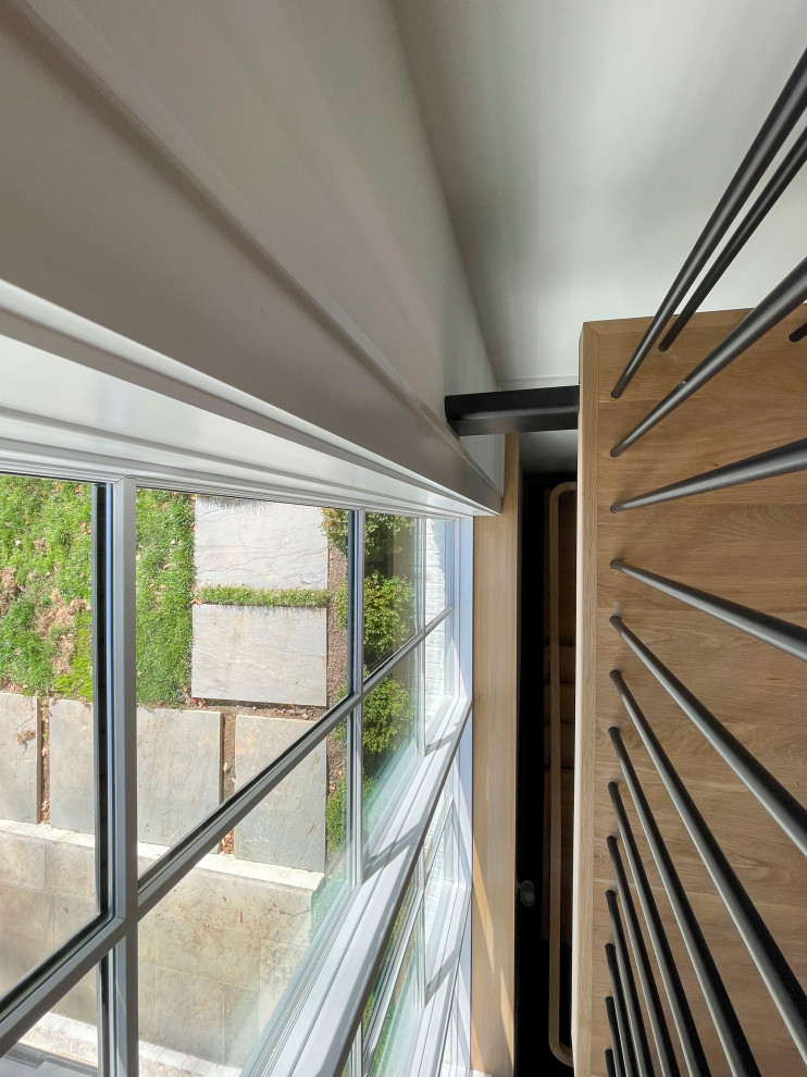 Inspiration for an expansive modern wood floating mixed railing staircase in DC Metro with tongue and groove walls.