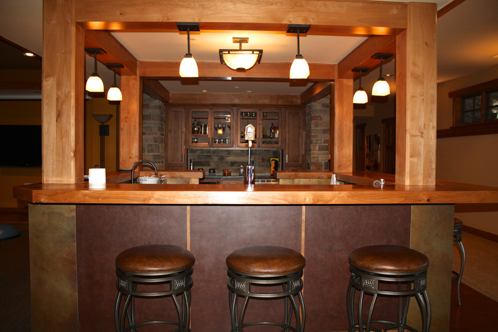 This is an example of a mid-sized traditional u-shaped wet bar in Denver with shaker cabinets, dark wood cabinets and wood benchtops.