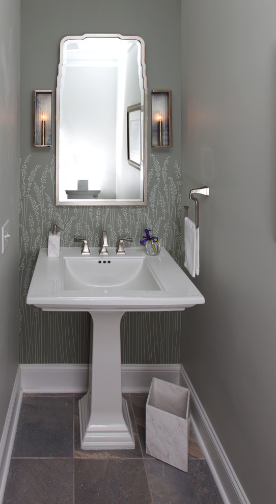 Photo of a small transitional powder room in Raleigh with a two-piece toilet, grey walls, slate floors, a pedestal sink, solid surface benchtops and grey floor.