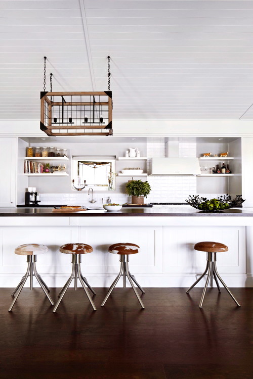 Modern kitchen featuring four backless stool with a cowhide design pattern on the seats