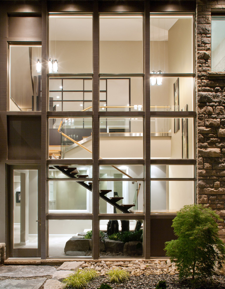 Design ideas for a contemporary exterior in Ottawa with stone veneer.