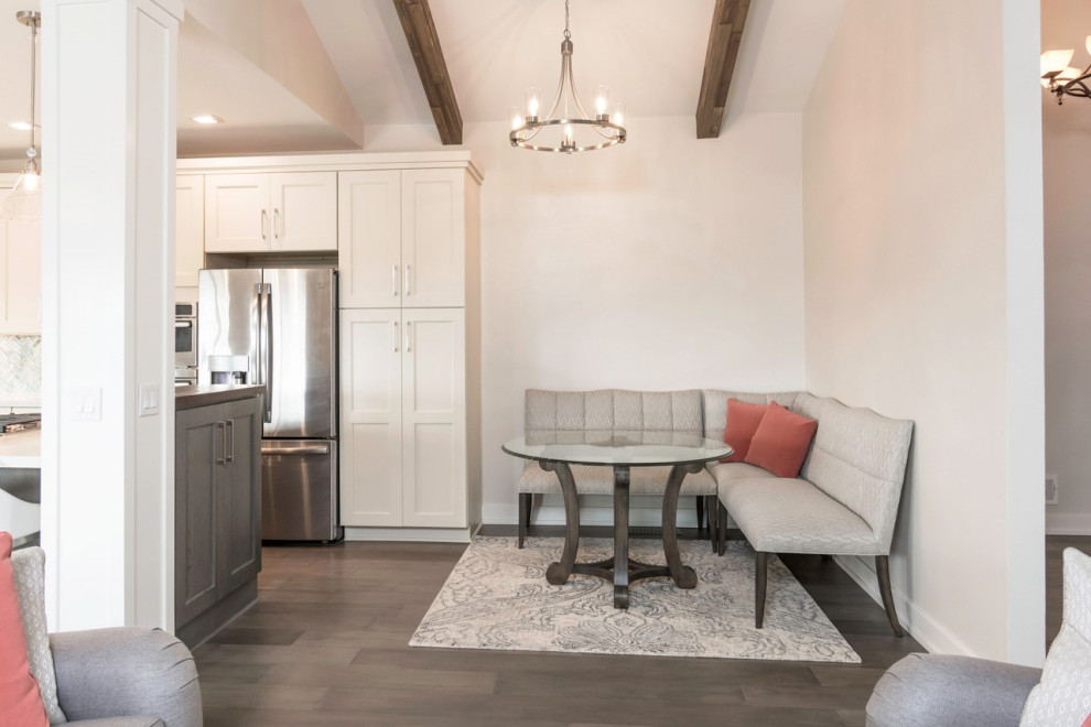 Large transitional l-shaped dark wood floor eat-in kitchen photo with an undermount sink, shaker cabinets, white cabinets, quartz countertops, blue backsplash, glass tile backsplash, stainless steel appliances, an island and white countertops