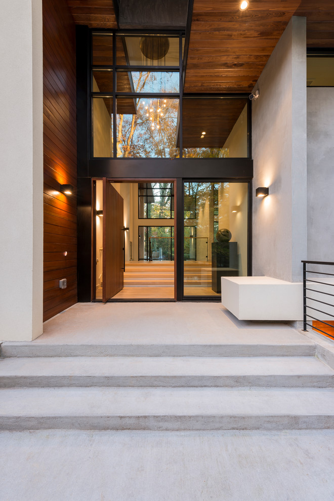 Inspiration for a modern entryway in Atlanta with a pivot front door and a medium wood front door.
