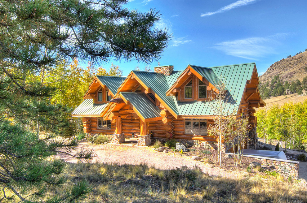 Inspiration for a large rustic brown two-story wood gable roof remodel in Denver with a metal roof