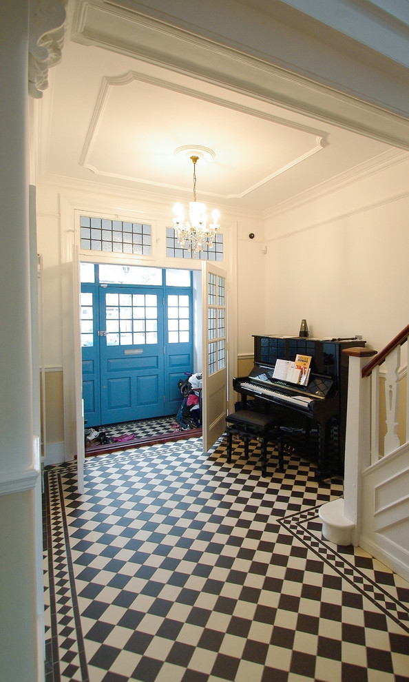 This is an example of a mid-sized traditional hallway with white walls, terra-cotta floors and multi-coloured floor.