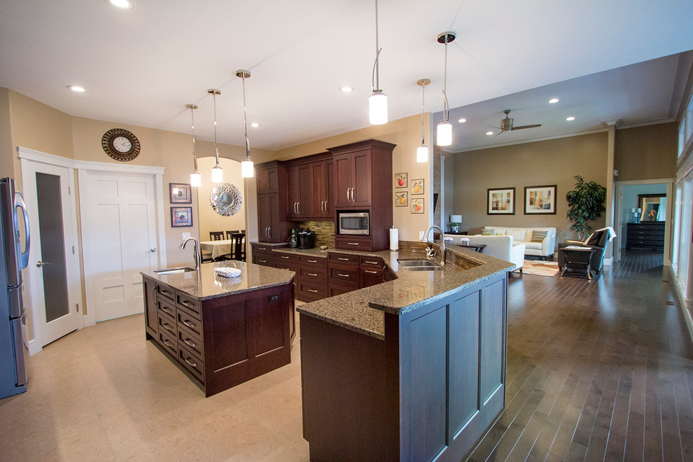 Example of a mid-sized transitional l-shaped enclosed kitchen design with an undermount sink, recessed-panel cabinets, medium tone wood cabinets, granite countertops, stainless steel appliances and an island