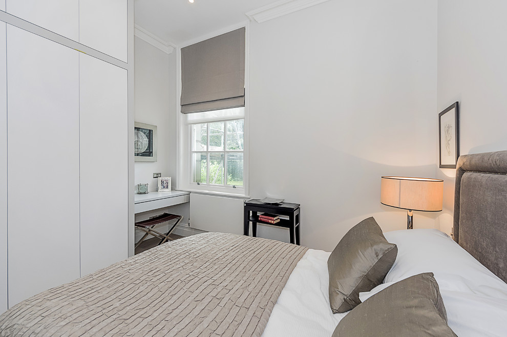Design ideas for a small contemporary guest bedroom in London with grey walls and light hardwood floors.